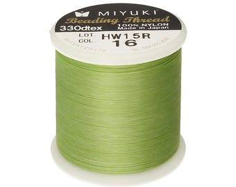 May include: A spool of green Miyuki Beading Thread, 330dtex, 100% nylon, made in Japan. The spool is labeled with the lot number HW15R and color number 16.