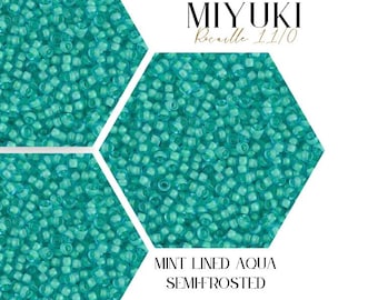 May include: Close-up of a pile of small, turquoise-colored glass beads. The beads are Miyuki brand, size 11/0, and are described as "Mint Lined Aqua Semi-Frosted".