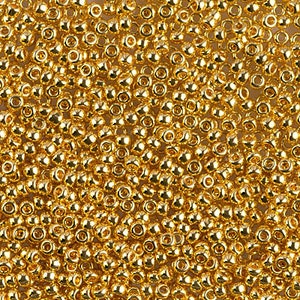 K&ouml;nnte beinhalten: Nahaufnahme einer gro&szlig;en Menge kleiner, runder, goldfarbener Perlen. Die Perlen haben eine gl&auml;nzende, metallische Oberfl&auml;che.