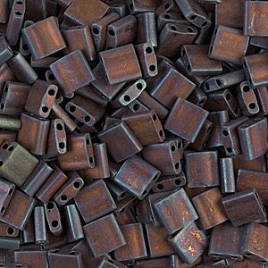May include: A pile of small, dark brown, square-shaped glass beads with two holes in each bead.