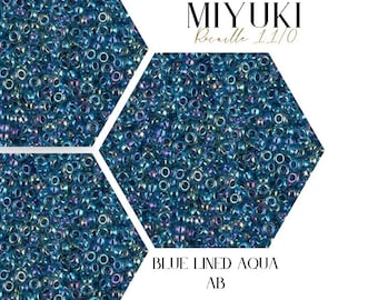 May include: Close-up of blue lined aqua Miyuki seed beads with an iridescent finish. The beads are arranged in a hexagonal pattern. The text "MIYUKI Rocaille 11/0" and "BLUE LINED AQUA AB" are visible in the image.  WAYFINDER BEAD SUPPLY is also visible in the image.