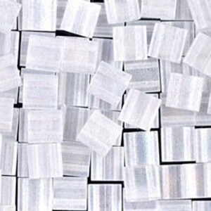 May include: A pile of small, white, iridescent glass tiles. The tiles are square and have a slightly textured surface.