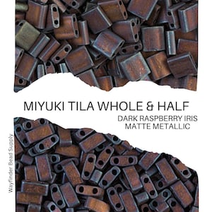 May include: A close-up of a pile of dark raspberry iris matte metallic Miyuki Tila beads. The beads are a mix of whole and half beads.