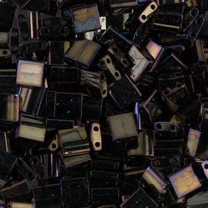 May include: A pile of small, square, iridescent black glass beads with two holes in each bead.