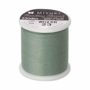 May include: A spool of sage green Miyuki beading thread made of 100% nylon. The white plastic spool features a black label with the text Miyuki Beading Thread, 330dtex, 100% Nylon, Made in Japan, Lot WH25R, and Col. 23 printed on the top surface.