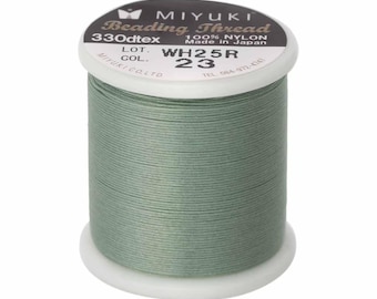 May include: A spool of sage green Miyuki beading thread made of 100% nylon. The white plastic spool features a black label with the text Miyuki Beading Thread, 330dtex, 100% Nylon, Made in Japan, Lot WH25R, and Col. 23 printed on the top surface.