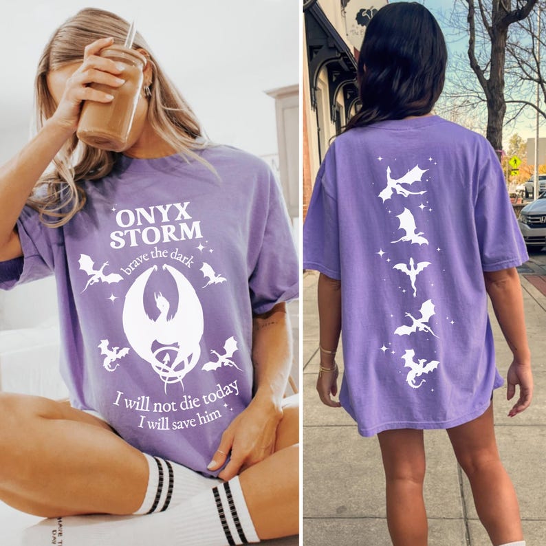 May include: Purple t-shirt with a white graphic of a dragon and the text "ONYX STORM brave the dark" on the front. The back of the shirt has a white graphic of five dragons.