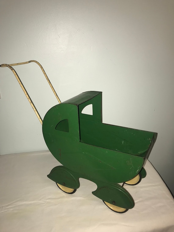 Vintage metal doll buggy, carriage.