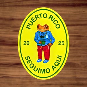 May include: A yellow and green circular sticker with the text "PUERTO RICO" and "SEGUIMO AQUI" around a cartoon frog wearing a blue jacket, red pants, and blue shoes. The frog is holding a green cup and a camera.