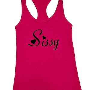 May include: A pink tank top with a black graphic that says "Sissy" with two hearts.