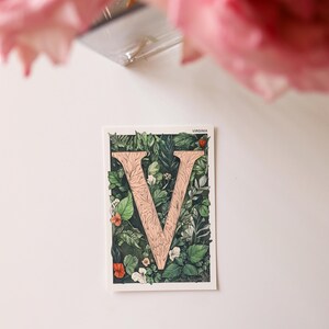 Virginia 4x6 postcard featuring the letter "V" decorated with lush green leaves and botanical details, celebrating the state's rich natural beauty. A perfect 4x6" Virginia souvenir, printed on high-quality matte cardstock for nature lovers, postcrossers, and plant enthusiasts.
