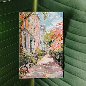 Illustrated postcard of a summer day in Georgetown, Washington, DC, featuring bicycles, colorful row houses, and lush greenery. Printed on a 4x6" matte cardstock, perfect for mailing or collecting.
