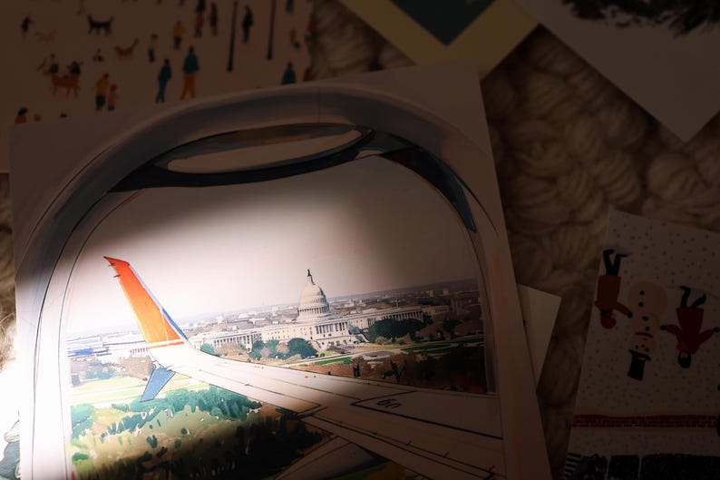 Hand-drawn Washington DC postcard featuring watercolor and ink illustration with the US Capitol Building seen from the airplane window. Elegant 4x6 postcard with watercolor-style artwork, perfect for Washington DC tourists, DC locals, collectors, post crossers, and travel souvenirs collectors.
