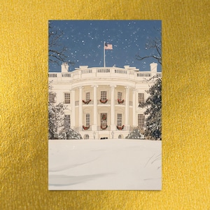 Washington DC Christmas postcard featuring a festive gouache illustration of the White House covered in snow and decorated for the holidays. A perfect DC winter souvenir, holiday greeting card, or collectible art print for Christmas decor lovers, Washington DC travelers, White House history buffs, and postcard collectors. Printed on premium 4x6 matte cardstock with high-resolution festive artwork. Designed and made in the USA.