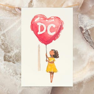 Watercolor illustration of a girl holding a red heart-shaped balloon with "DC" written on it, standing near The Washington Monument. The charming postcard captures the spirit of Washington, DC, with a dreamy, whimsical touch. Perfect for DC lovers, travel enthusiasts, and postcard collectors, this 4x6 design makes a unique souvenir or gift. Printed on premium cardstock with a matte finish, it’s ideal for mailing, framing, or adding to your collection.
