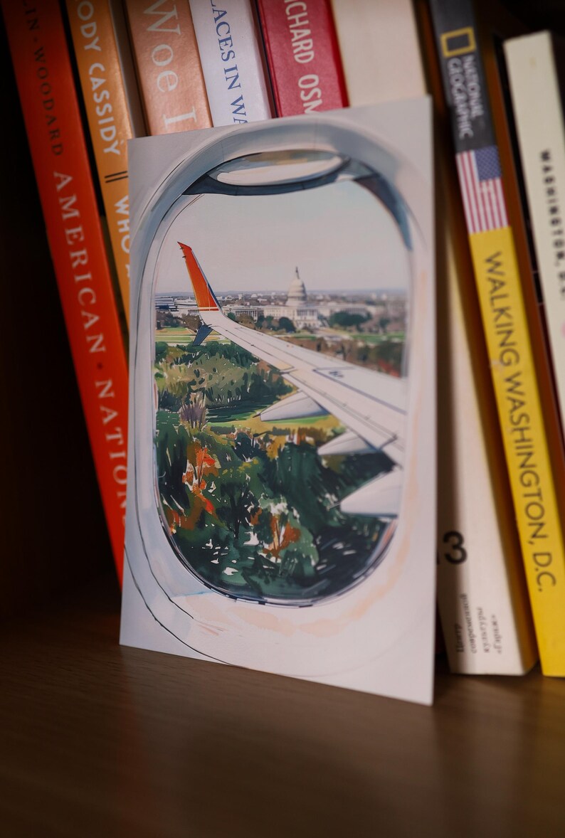 Hand-drawn Washington DC postcard featuring watercolor and ink illustration with the US Capitol Building seen from the airplane window. Elegant 4x6 postcard with watercolor-style artwork, perfect for Washington DC tourists, DC locals, collectors, post crossers, and travel souvenirs collectors.