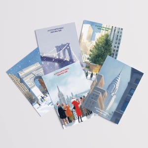 Pode incluir: Um conjunto de postais com ilustrações de inverno de Nova Iorque. Cada postal apresenta cenas diferentes, incluindo a Ponte do Brooklyn e o Empire State Building, com o texto "A Little Winter Magic From New York".