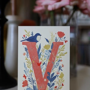 Virginia postcard featuring the letter "V" decorated with delicate floral patterns and charming birds. A 4x6" nature-inspired Virginia souvenir, printed on premium matte cardstock, celebrating the state's natural beauty and wildlife.
