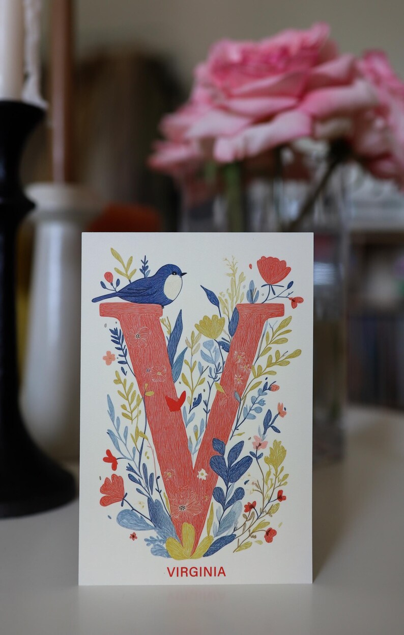 Virginia postcard featuring the letter "V" decorated with delicate floral patterns and charming birds. A 4x6" nature-inspired Virginia souvenir, printed on premium matte cardstock, celebrating the state's natural beauty and wildlife.