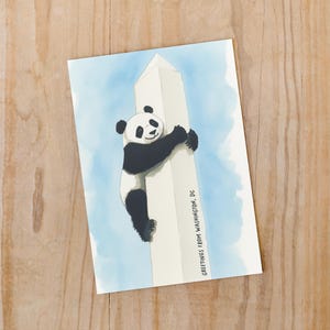 Washington DC postcard featuring a whimsical illustration of a giant panda climbing The Washington Monument. A fun and charming souvenir celebrating the return of pandas to DC. Perfect gift for panda lovers, Washingtonians and Washington, DC enthusiasts!