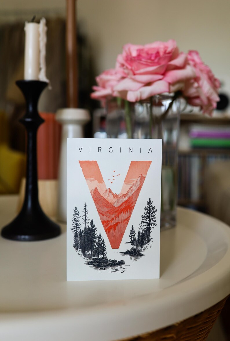 Virginia postcard featuring the letter "V" artistically intertwined with lush forests and majestic mountain peaks. A perfect 4x6" Virginia souvenir celebrating the state’s natural beauty. Printed on premium matte cardstock, ideal for nature lovers, hikers, and adventure seekers.