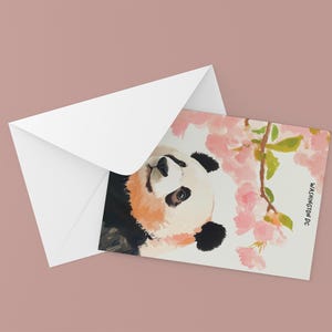Charming Washington DC postcard featuring a whimsical watercolor and ink illustration of a giant panda lounging under blooming cherry blossom trees. A delightful National Mall souvenir, perfect for panda lovers, cherry blossom fans, and DC visitors.