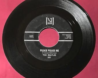 May include: Black and white vinyl record with the title "Please Please Me" by The Beatles. The record label is Vee-Jay Records and the song length is 2.00 minutes.