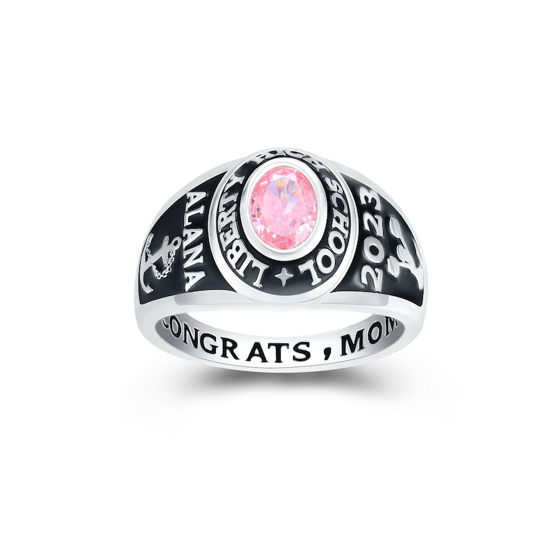 May include: A silver class ring with a black band and a pink stone. The ring says "Liberty School" and "2023" on the top and "Alana Congrats, Mom" on the bottom.