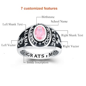 May include: A silver class ring with black lettering. The ring features a pink birthstone, the words "ALANA LIBERTY SCHOOL 2023", and the inscription "CONGRATS, MOM".