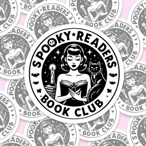May include: A black and white sticker with a spooky reader theme. The sticker features a woman with a cat reading a book. The text on the sticker reads "Spooky Readers Book Club".