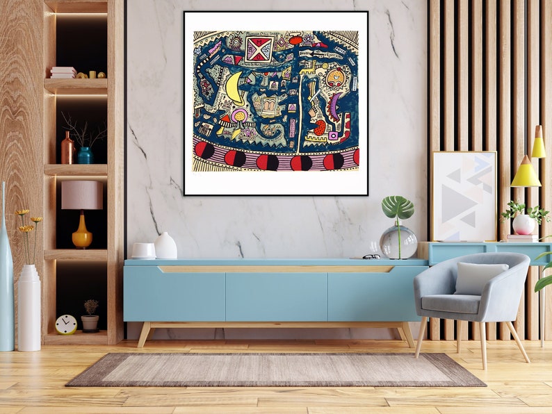 May include: A framed abstract art print with a colorful, geometric design. The print features a blue background with red, yellow, and white shapes. The print is framed in a black frame and is hanging on a white wall.
