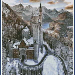May include: A fairytale-like castle with white snow-covered roofs and towers, nestled in a snowy mountain landscape with a frozen lake in the background.
