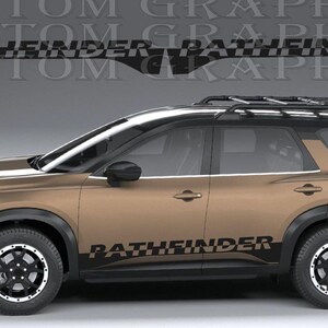 May include: A bronze-coloured SUV featuring a black roof rack, black wheels, and a black vinyl decal on the lower side panel that reads PATHFINDER. The vehicle is displayed against a grey background with a watermark text overlay reading CUSTOM GRAPHICS.