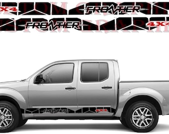 May include: A silver pickup truck with black and red decals that say "FRONTIER" and "4X4".