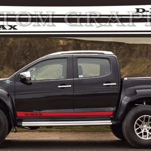 May include: A black pickup truck with a red and black stripe decal on the side. The decal says "D-MAX".