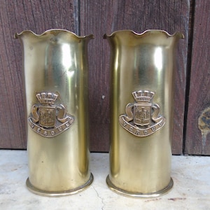 pair of ww1 trench art pom pom shell casings both with verdun emblems