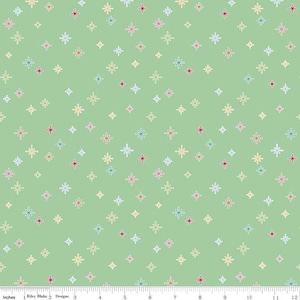 May include: A green fabric with a repeating pattern of colorful stars. The stars are outlined in white and have a variety of colors, including red, blue, yellow, and pink.
