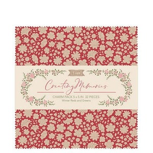 May include: A charm pack of 32 fabric squares, each measuring 5 inches by 5 inches. The fabric features a red background with a white floral pattern. The pack is titled "Creating Memories" and includes "Winter Reds and Greens".