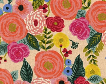 May include: A floral print fabric with a cream background and a variety of colorful flowers, including pink, red, orange, yellow, and blue. The flowers are arranged in a random pattern and are surrounded by green leaves.