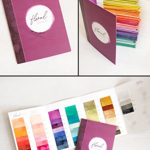 May include: A fabric swatch book with a purple cover and the text "floral fabrics" in a white circle. The book is open to reveal rows of colorful fabric swatches.