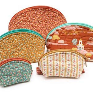 May include: A set of four semi-circular quilted pouches in varying sizes. The largest features a small orange floral print, while others display a mustard yellow floral pattern, a landscape scene with a building, a teal floral print, and a striped floral design.