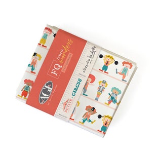 May include: A stack of fabric fat quarters with a circus theme. The fabric features cartoon circus performers in various poses on a white background. The fabric is wrapped with a red band that reads "fabric wonders" and "Petite Circus".