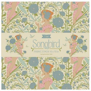 May include: A fabric stack featuring a repeating pattern of women, flowers, and foliage in shades of pink, blue, and green on a cream background. The text "Songbird" is displayed on a banner, with the dimensions of the fabric stack being 10 x 10 inches.