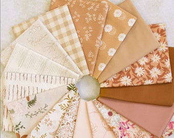 May include: A collection of 14 fabric squares in various shades of brown, beige, and pink with floral and geometric patterns. The fabric squares are arranged in a circle.