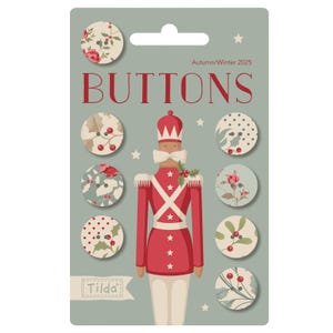 May include: A package of decorative buttons with floral and berry patterns. The package features a red and white toy soldier illustration and the word "BUTTONS". The text "Autumn/Winter 2025" is also present.