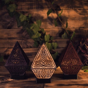 Three viking lamps in different colors. Black on the left, natural burnt wood in the center and dark brown on the right.