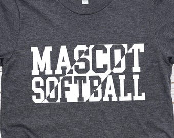 May include: Dark gray t-shirt with the words "MASCOT SOFTBALL" in large white block letters. The shirt has rolled-up sleeves and a crew neck. The shirt is made of a soft material.