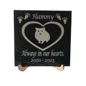 May include: Black slate pet memorial with a white engraved heart, paw prints, and the text "Hammy Always in our hearts. 2020 - 2023".