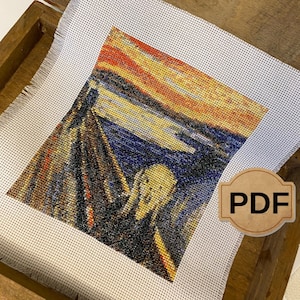 May include: A cross-stitch pattern of Edvard Munch's The Scream, featuring a figure with a distorted face against a swirling background of a blood-red sunset and a blue fjord. The pattern is displayed in a wooden box with a "PDF" label.