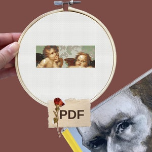 May include: A cross-stitch pattern featuring two cherubs, one with a crown and the other with a flower, in a vintage style. The pattern is in a hoop and labeled "PDF".